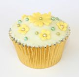 golden muffin - Sponge muffin decorated with butter icing, hand cut flowers and gold and green balls.