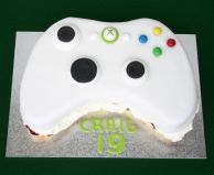 X Box Cake - Our all butter Victoria sponge cake filled with raspberry conserve and lashings of whipped cream, cut to shape and decorated to look like an X Box.